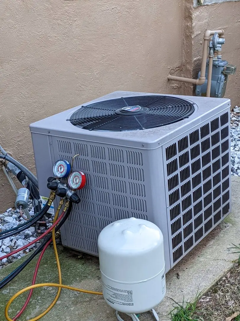 Refrigerant gauges connected to a condenser during a Central Washington Heating and Air service call